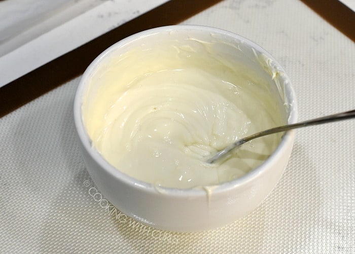 A bowl of melted white chocolate cookingwithcurls.com