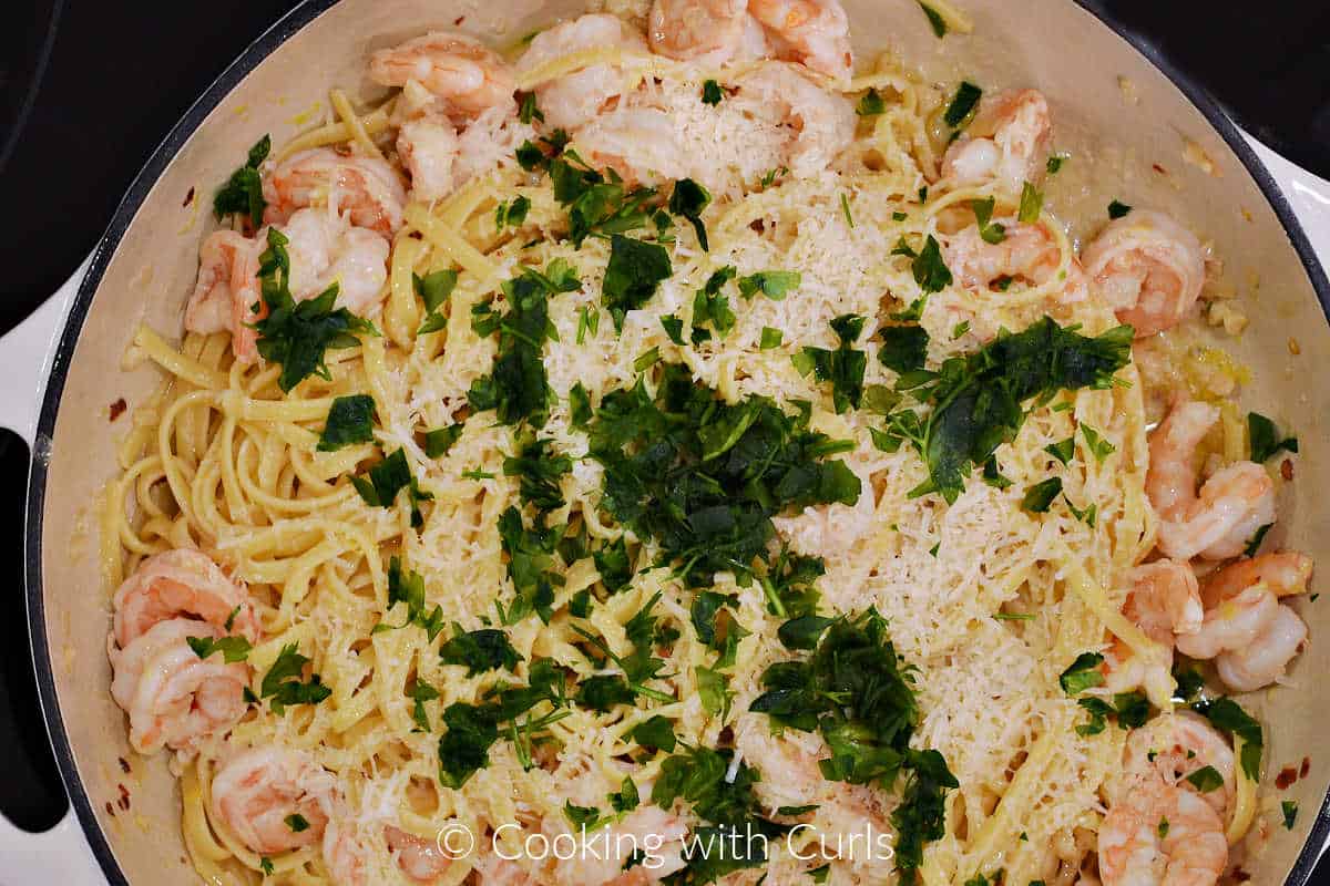 Chopped parsley, parmesan cheese, shrimp, and linguine in a large skillet.