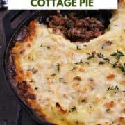Cottage Pie topped with cheesy potatoes with a scoop of beef filling scooped out of a cast iron skillet with title graphic across the top.