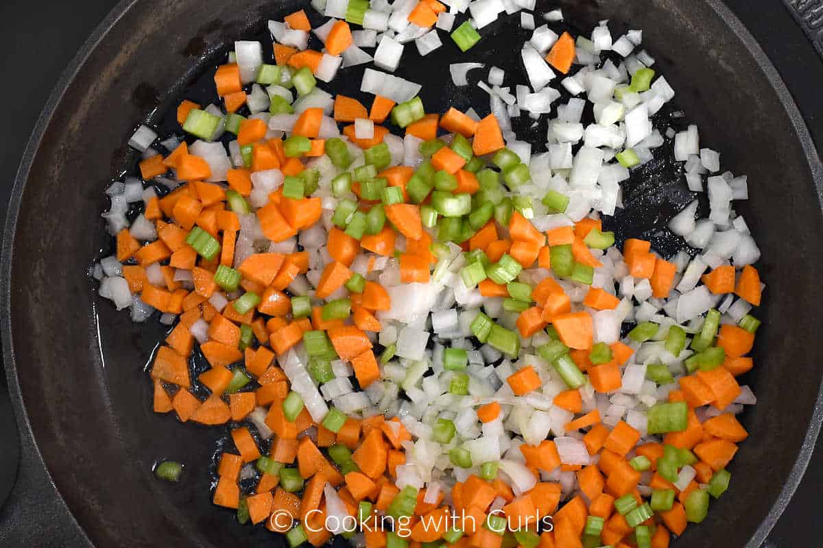 Diced onion, carrot, celery, and oil in a cast iron skillet. 