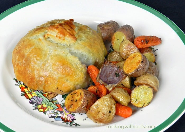 Beef Wellington served with roasted vegetables on a Christmas plate