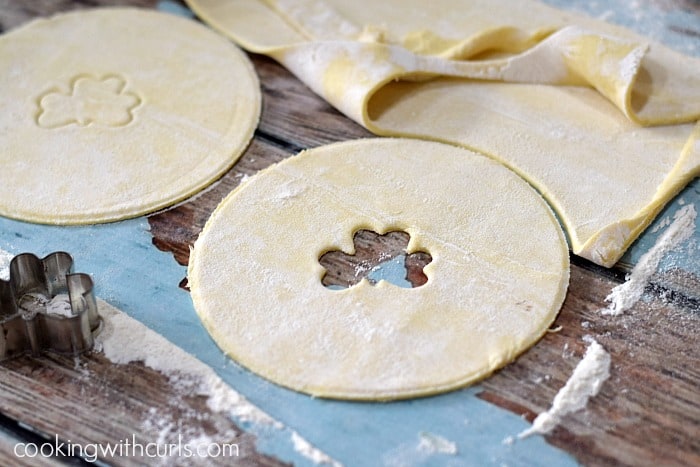 Small shamrock shapes cut into two puff pastry tops.