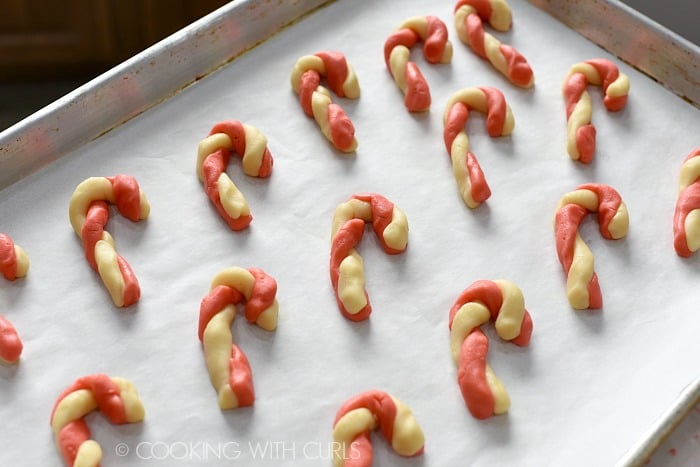 Place cookies on a parchment lined baking sheet and curve the top to form a cane cookingwithcurls.com