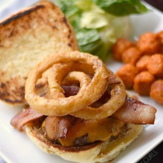 These big, juicy Guinness Burgers topped with Guinness Glaze, bacon and onion rings are the ultimate comfort food!! cookingwithcurls.com