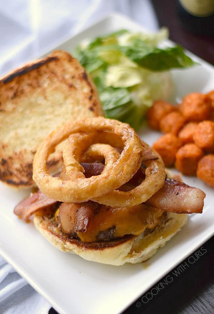 These big, juicy Guinness Burgers topped with Guinness Glaze, bacon and onion rings are the ultimate comfort food!! cookingwithcurls.com