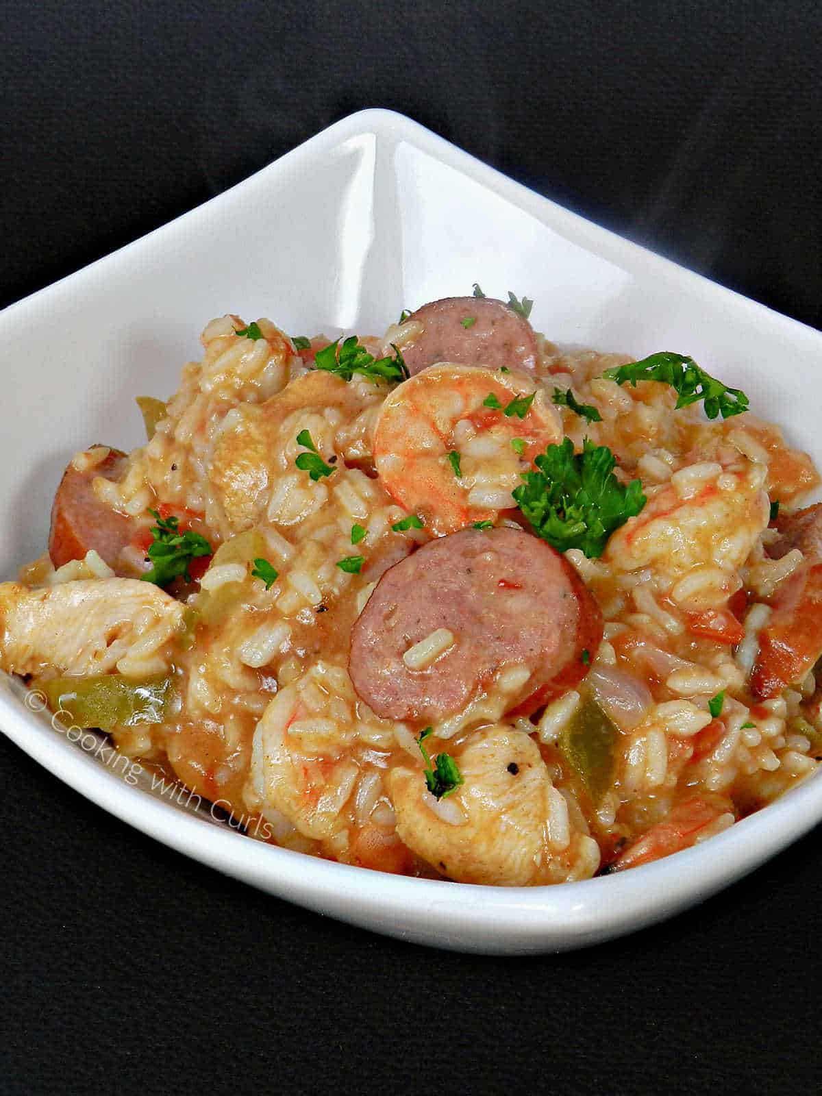 Shrimp Jambalaya with sliced sausage and chicken with rice in a bowl.
