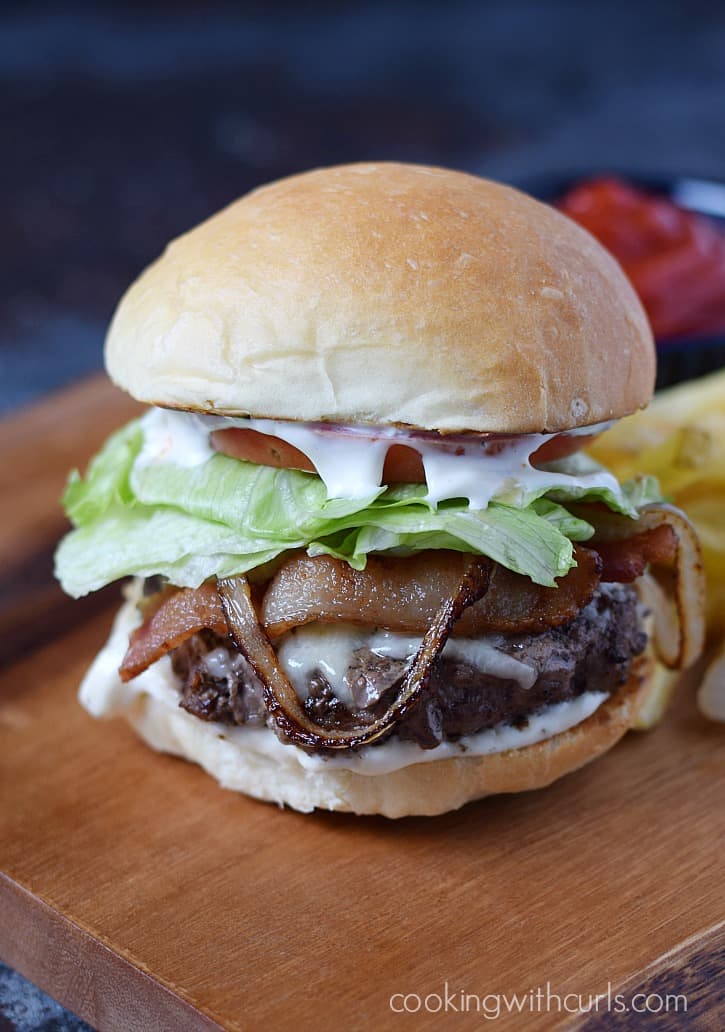 You have to try this Bistro Burger topped with garlic aioli, caramelized onions, thick bacon, and surrounded by soft, fluffy buns | cookingwithcurls.com