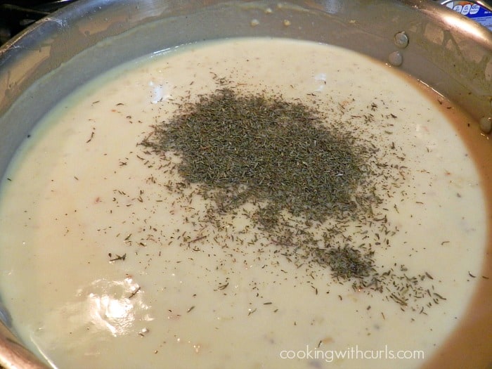 Dried thyme added to the thickened sauce in the large skillet.