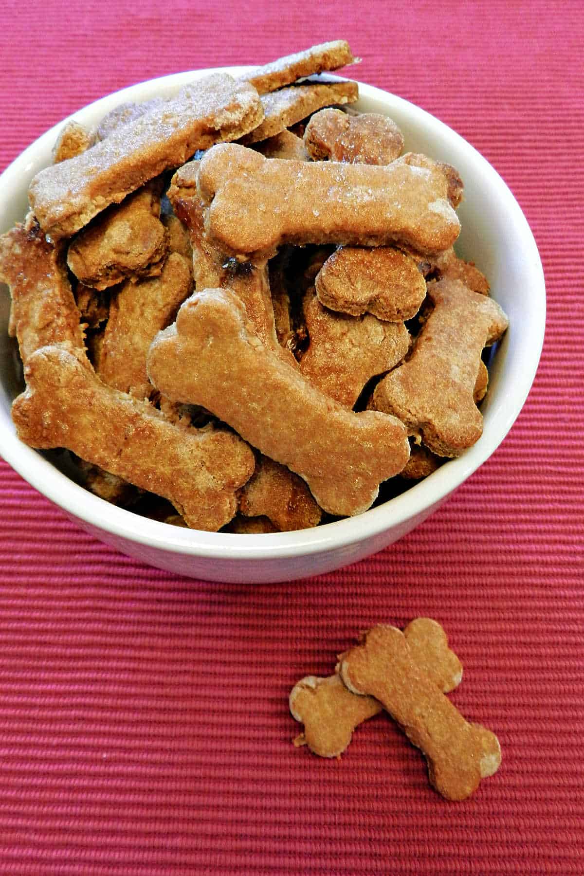 Bone-shaped dog biscuits in a small bowl.