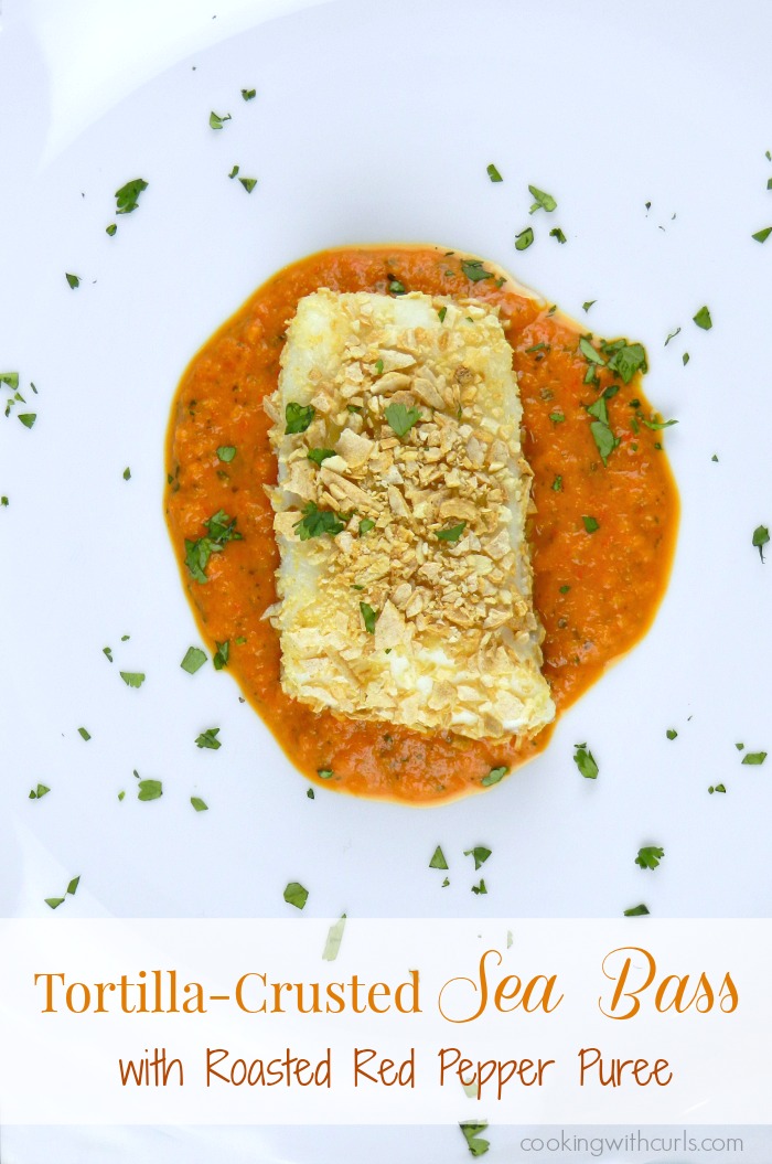 Tortilla-Crusted Sea Bass with Roasted Red Pepper Puree on a white plate.