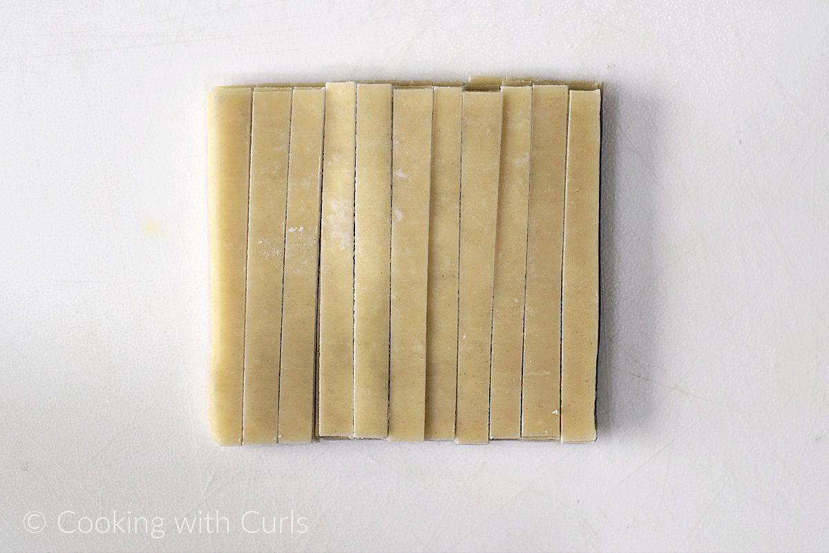 Wonton wrappers cut into eleven strips.