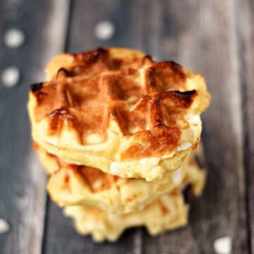 Three Belgian sugar waffles stacked on top of each other.