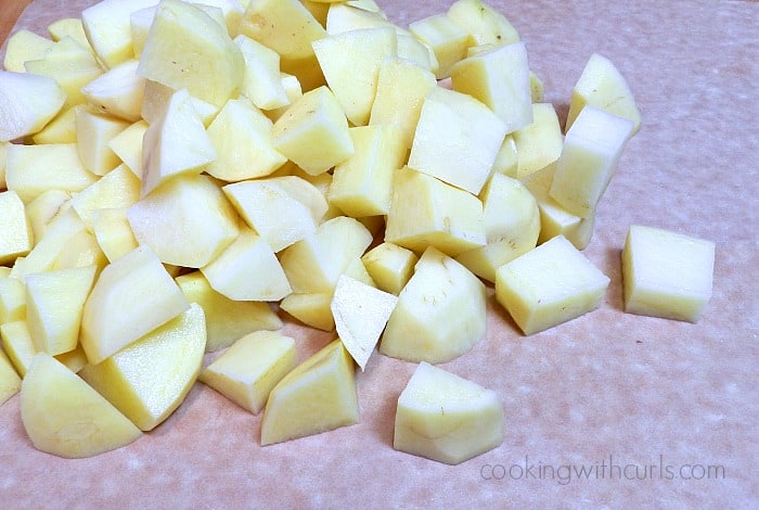 Raw potatoes chopped on a cutting board
