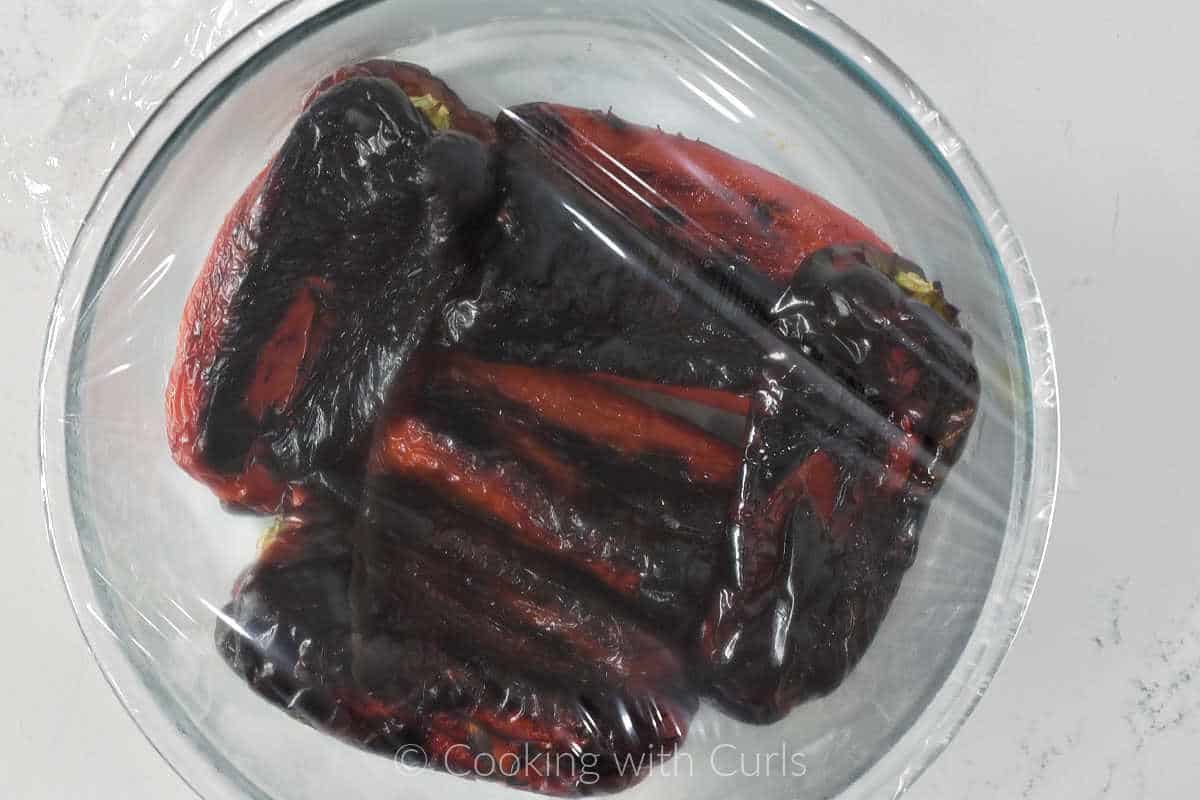 five-roasted-red-pepper-in-a-bowl-covered-with-plastic-wrap.