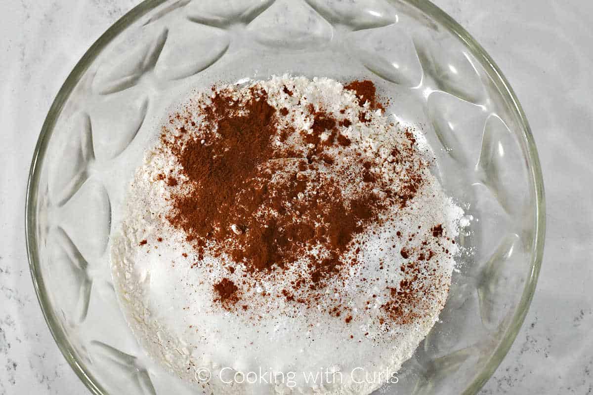 Flour, granulated sugar, baking powder, baking soda, and cinnamon in a large bowl.