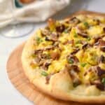 Breakfast Pizza with sausage gravy, eggs and bacon on a homemade pizza crust! cookingwithcurls.com