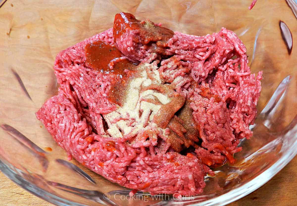 Ground beef and seasonings in a large mixing bowl.
