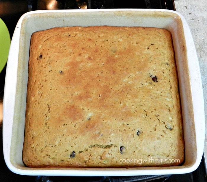 banana chocolate chip cake baked in a square baking dish sitting on top of the stove