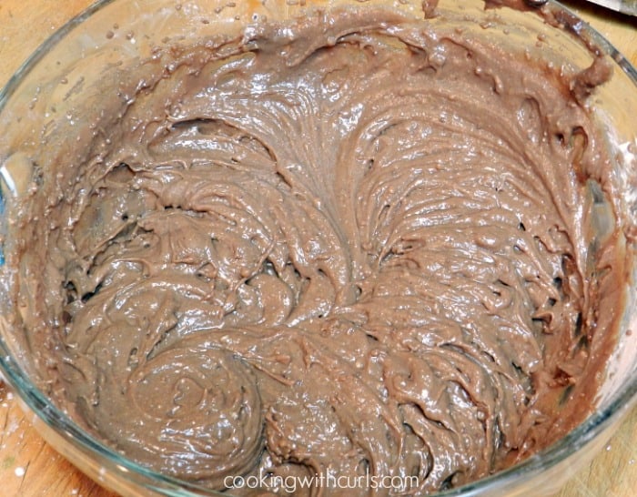 peanut butter frosting mixed together in a large, clear glass bowl
