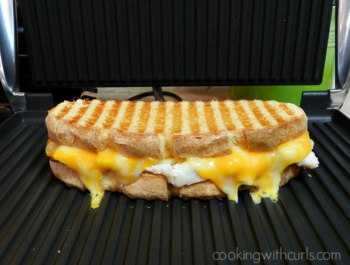 Sandwich with melted cheese grilled in a panini press.