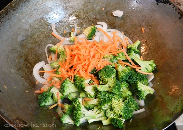Broccoli, carrots, and onions cooking in the wok.