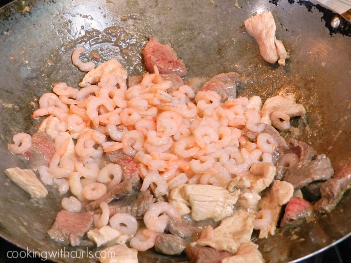 shrimp added to the wok with the steak and chicken.