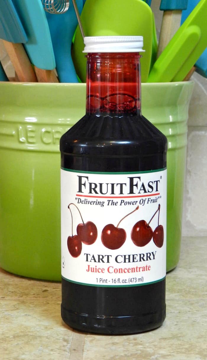 a bottle of cherry concentrate sitting on the counter