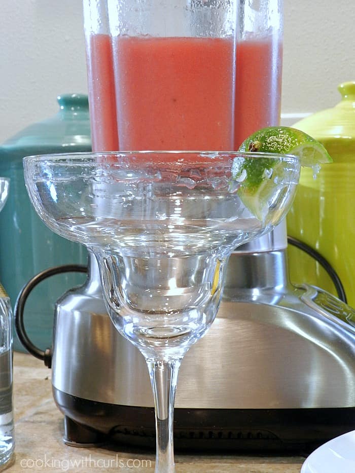 lime juice and sugar around the rim of a margarita glass.
