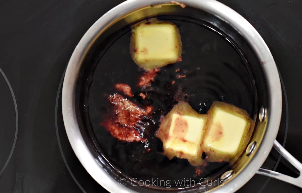 Mustard and three slices of butter with the reduced wine sauce in a saucepan. 