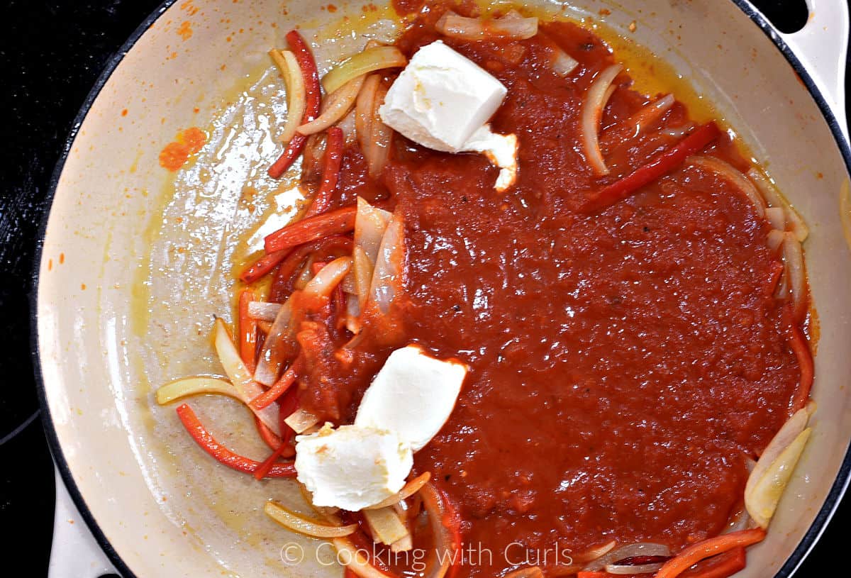 Sautéed onion and bell pepper slices, pizza sauce and chunks of cream cheese in a large skillet. 