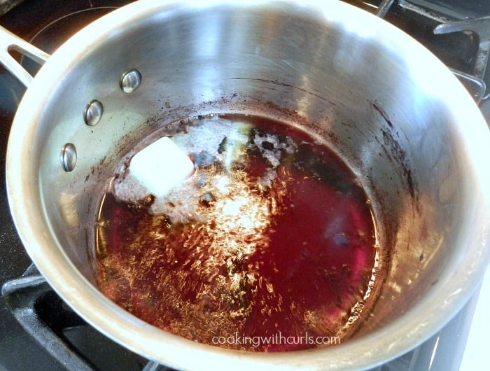 add butter to reduced red wine in a saucepan 
