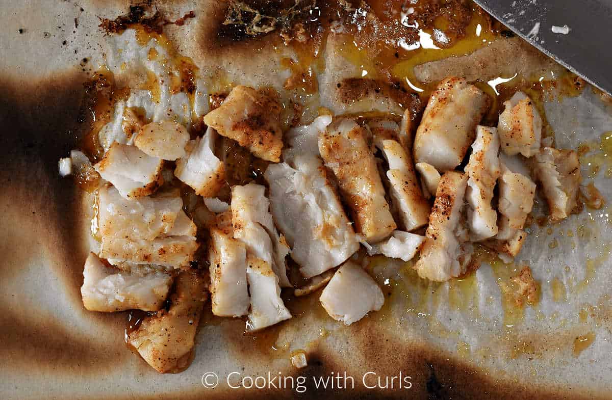 Broiled cod cut into bite-sized chunks.