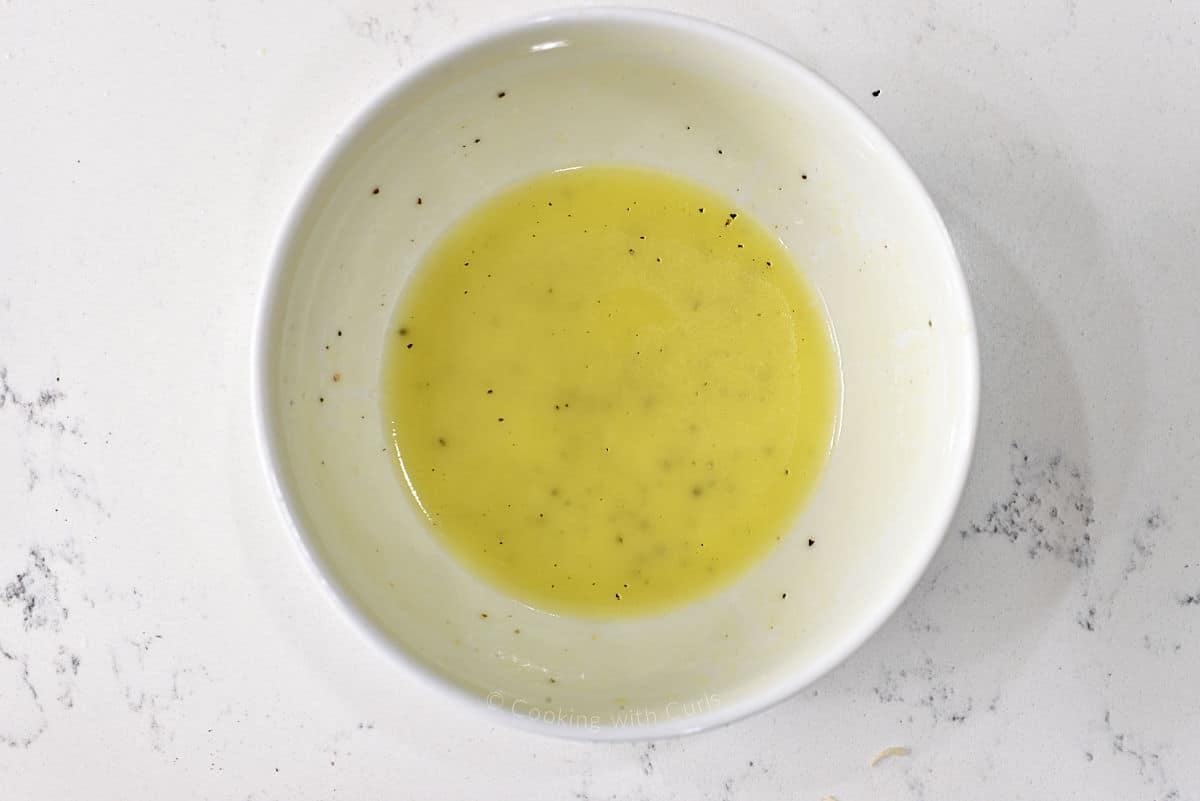 Lemon vinaigrette in a small bowl.