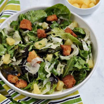 Shaved fennel salad with mixed greens, pineapple chunks and croutons.