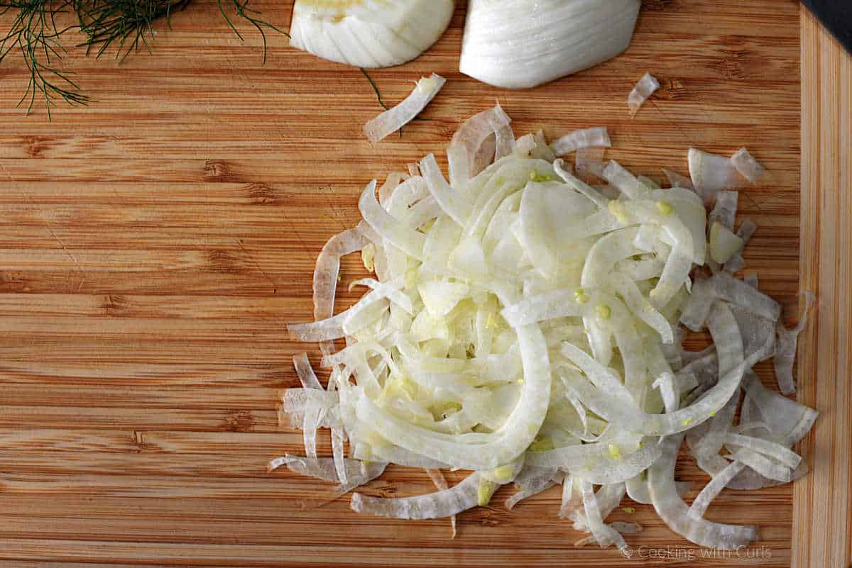 Shaved fennel on cutting board.