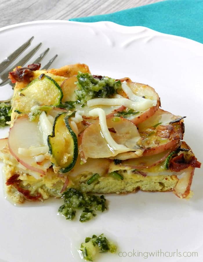 layers of Italian Frittata sliced into a wedge and served on a white plate