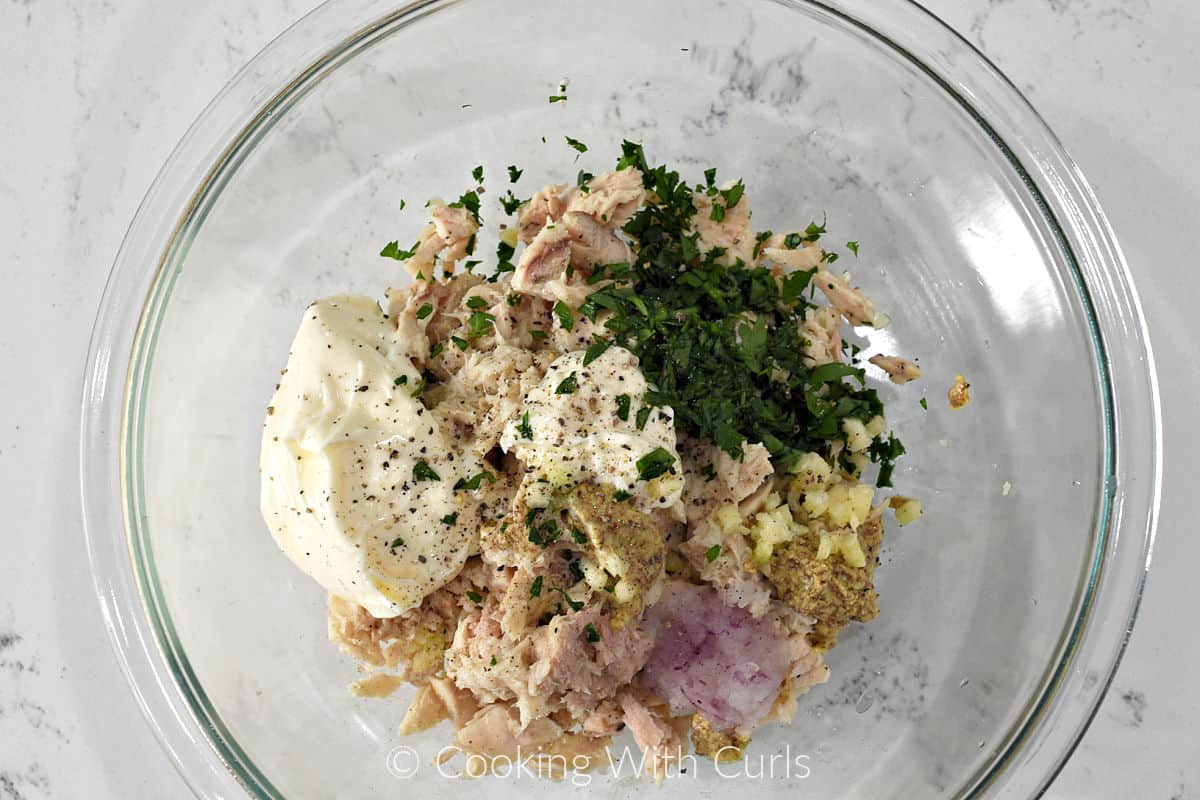 Tuna, mayo, garlic, grated red onion, parsley, and mustard in a large mixing bowl. 