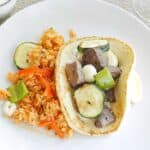 Greek marinated Lamb and Vegetable Kabobs, grilled to perfection with green peppers, zucchini, and pearl onions...served in heated pita with Tzatziki! cookingwithcurls.com