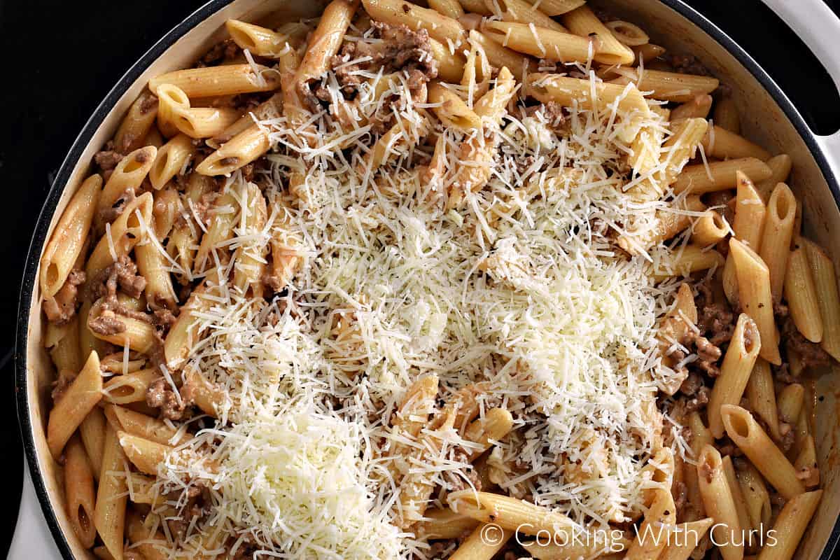 Grated parmesan cheese on top of the beef and pasta mixture in a large skillet. 