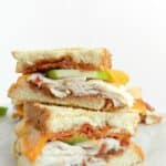 Apple butter, turkey, bacon and apple slices on grilled sourdough bread combine to make the ultimate Turkey Apple Panini! cookingwithcurls.com