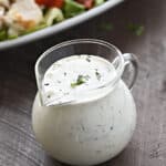 Homemade dairy free ranch dressing in a small glass pitcher.