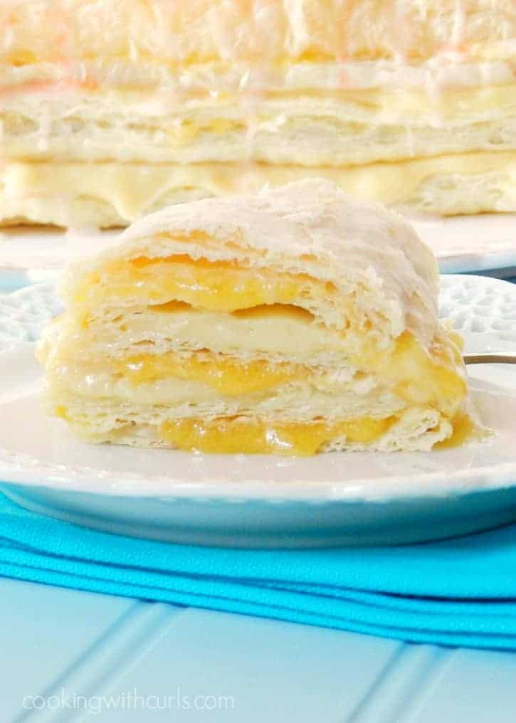 Rich vanilla pastry cream and fresh peach coulis are sandwiched between layers of puff pastry to form these incredible Peaches and Cream Napoleons cookingwithcurls.com