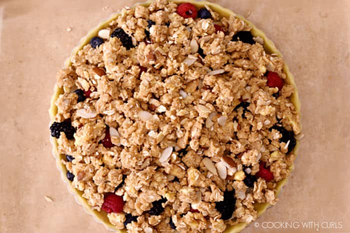 looking down over an oat and almond crumble topped berry tart.