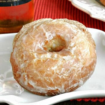 Apple ale doughnuts sitting on white plate.
