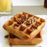Light and fluffy Pumpkin Waffles topped with maple syrup and toasted pecans! cookingwithcurls.com