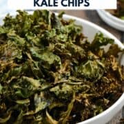 A large bowl filled with crispy, seasoned kale chips with title graphic across the top.