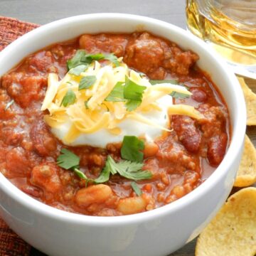 Jack Daniels Chili with corn chips and a glass of whiskey