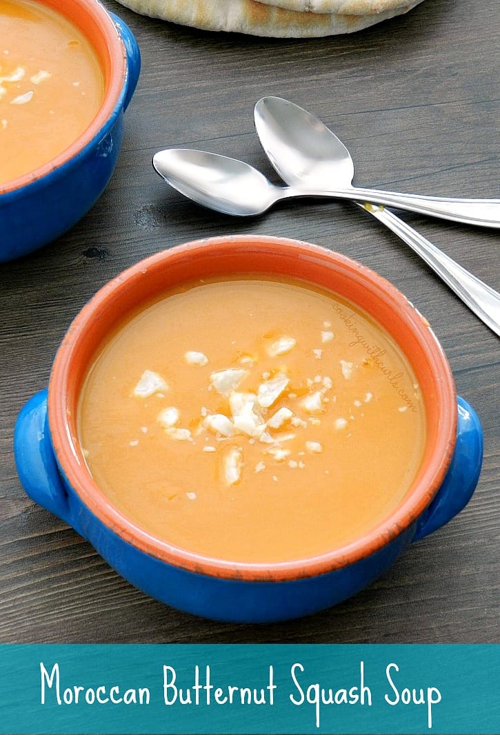 two blue bowls filled with Moroccan Butternut Squash Soup with spoons in the background