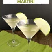 two martini glasses on a green napkin filled with caramel apple martinis and garnished with green apple slices with title graphic across the top.