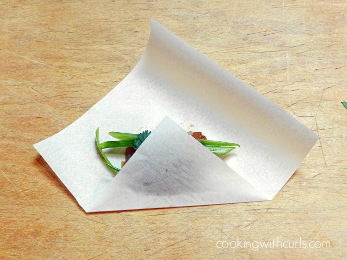 wrap the bottom of the paper up over the chicken